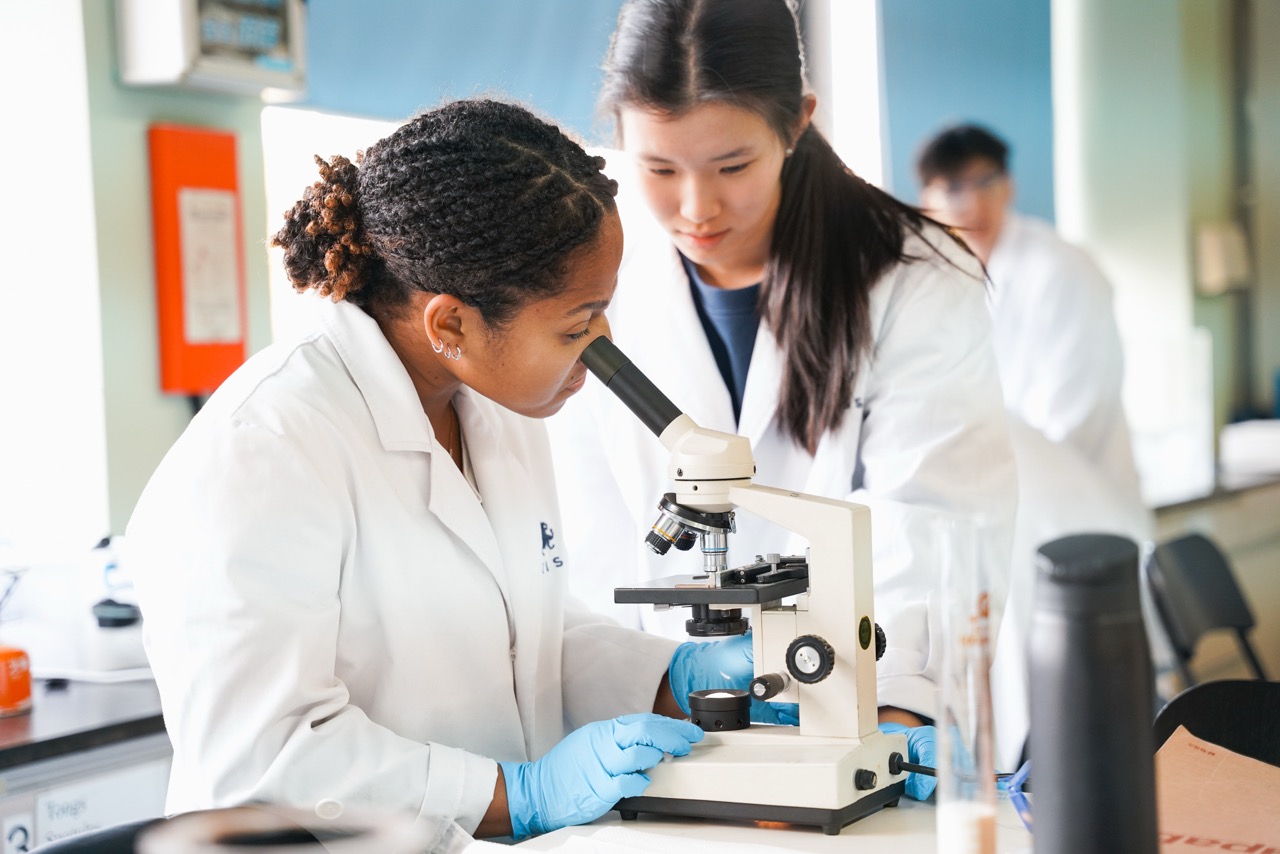 WISS teachers and students in the science lab